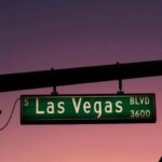 las vegas sign with a sunset in the background