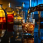Glass of bourbon on the rocks being poured at 1923 Prohibition Bar, one of the best bars in Las Vegas for whisky lovers.