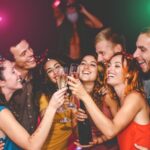 Group of friends celebrating a private event in Las Vegas at one of the best bars, laughing and raising glasses together.