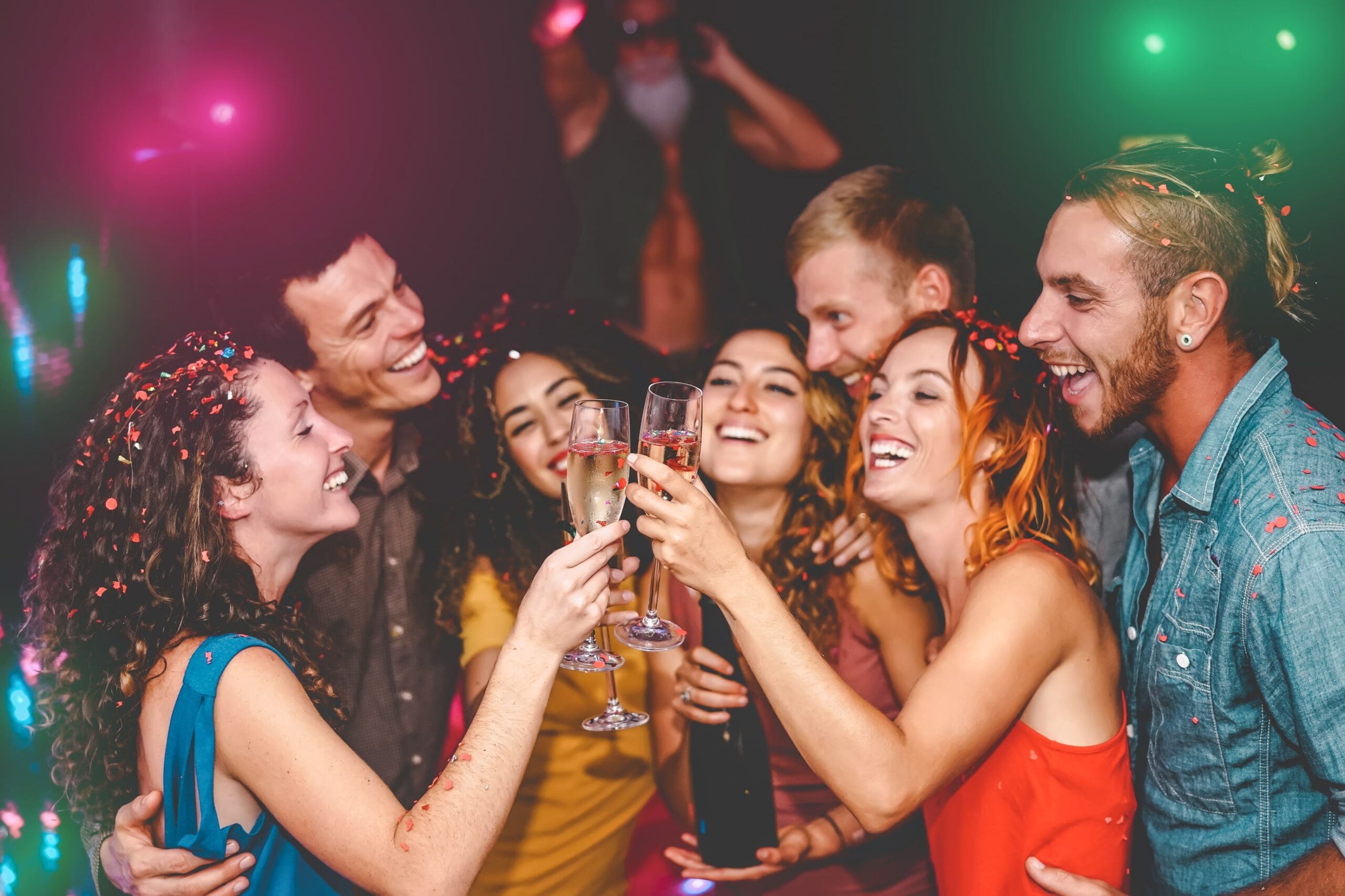 Group of friends celebrating with champagne at a private event in Las Vegas, enjoying one of the best bars in Las Vegas with a lively party atmosphere.