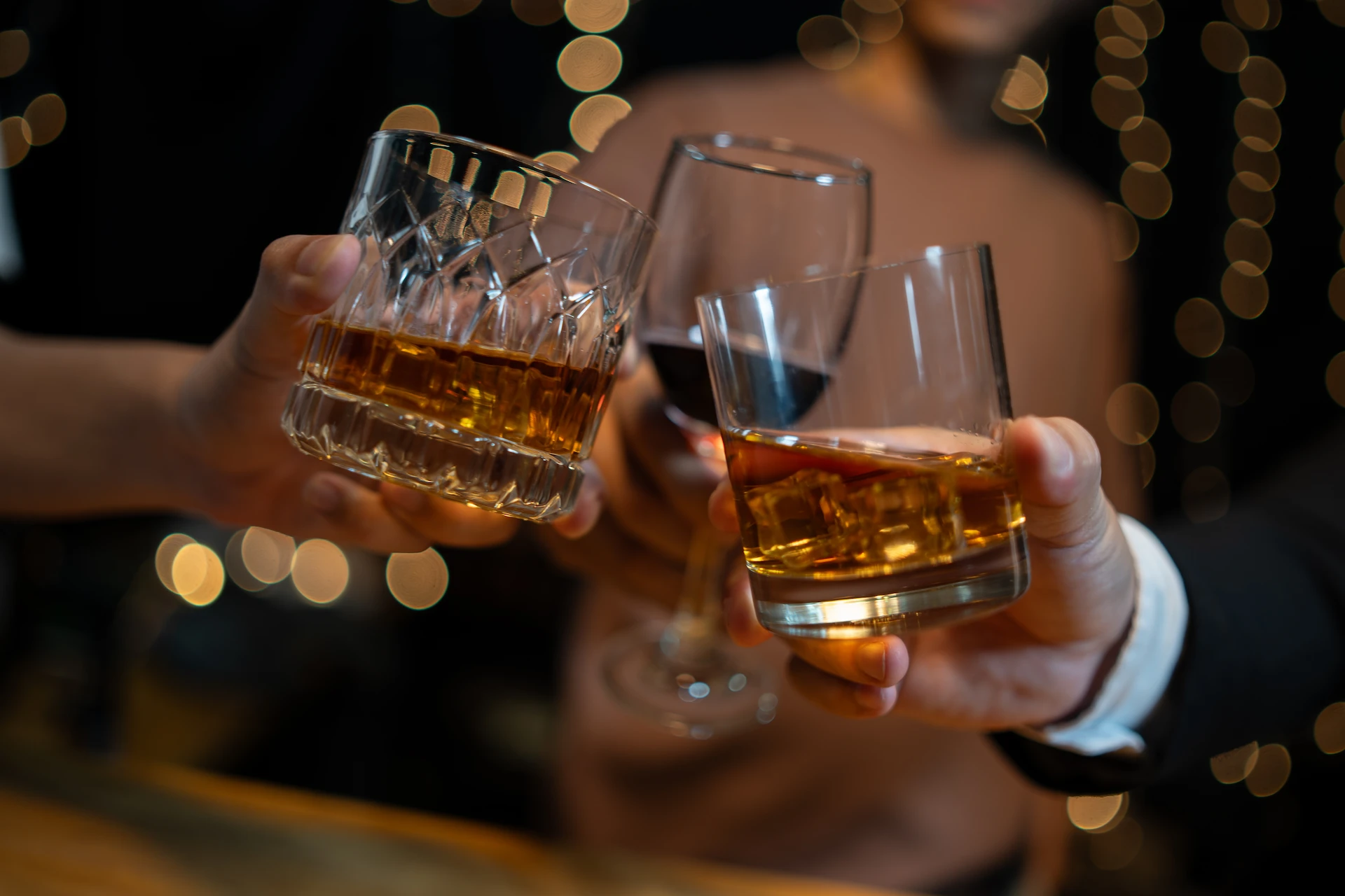 Guests toasting whiskey at 1923 Prohibition Bar. One of the best burlesque & bourbon bars in Las Vegas.