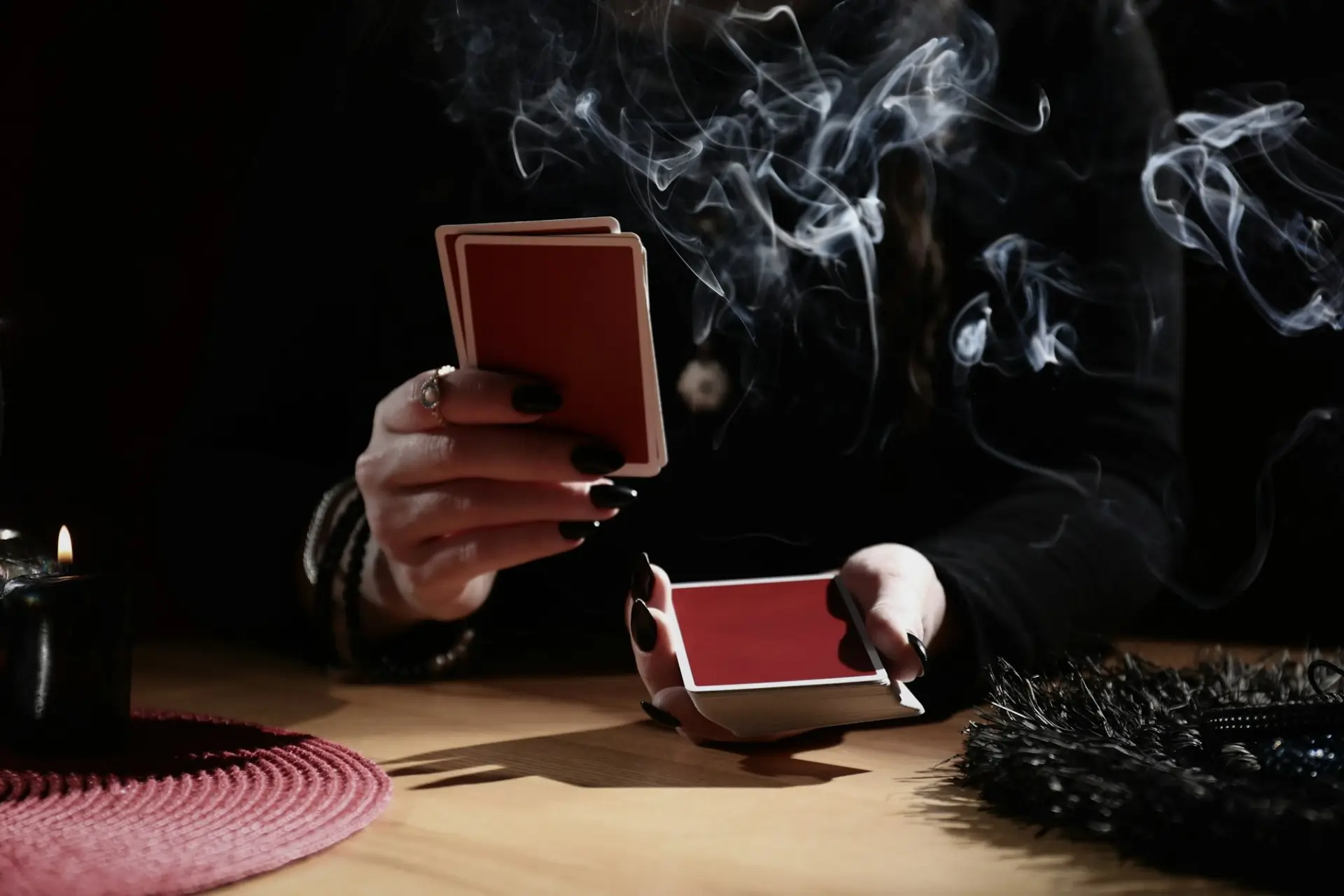 A close-up of a magician shuffling red playing cards during the Ghost Stories show at 1923 Prohibition Bar, widely named one of the best bars in Las Vegas for real Vegas horror stories.