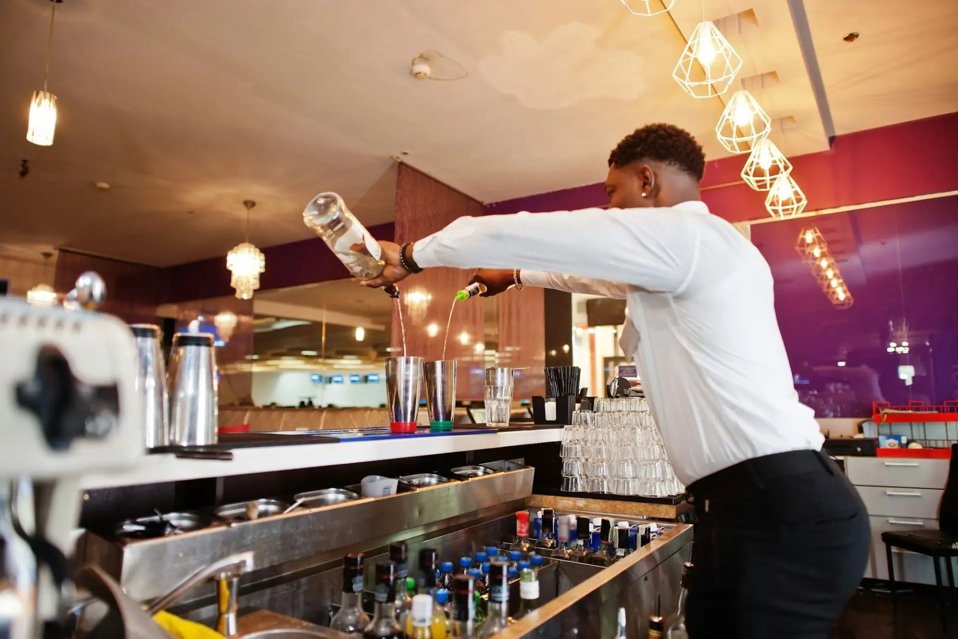 A bartender preparing craft cocktails at 1923 Prohibition Bar, the premier destination for bourbon and burlesque in Las Vegas.